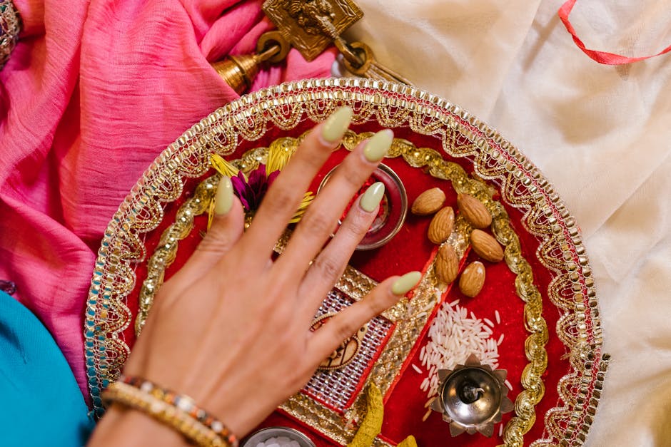 Intricate Diwali puja tray featuring a decorated hand, almonds, rice, and traditional elements in vibrant colors.
